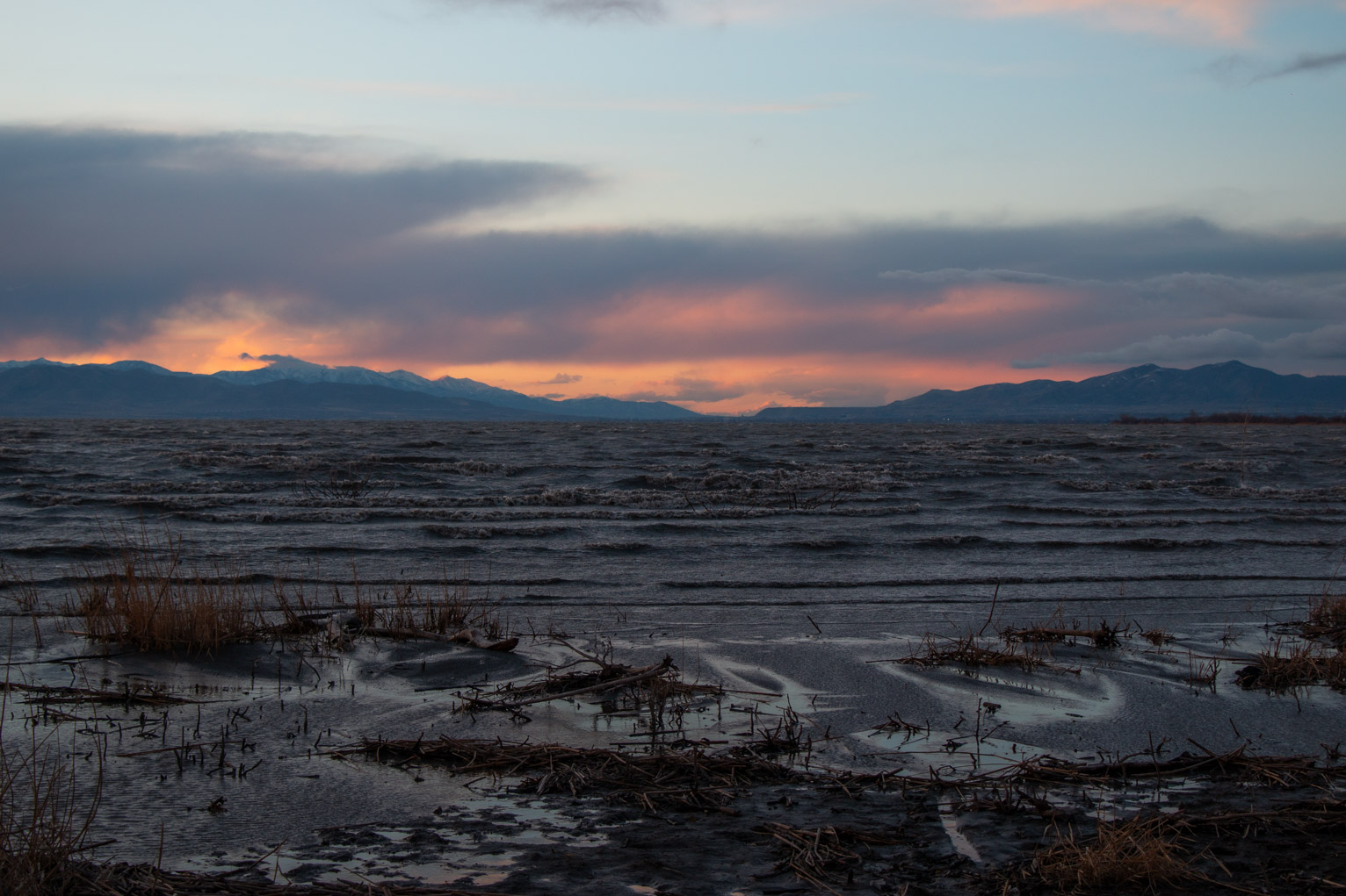 Intense dark waves come directly away from the sunset lit clouds